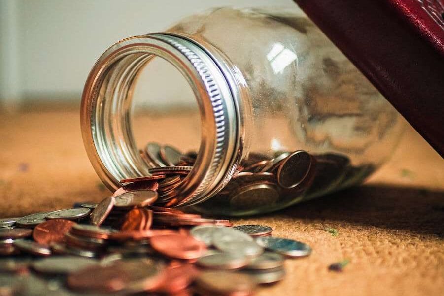 assorted coin lot in clear glass jar